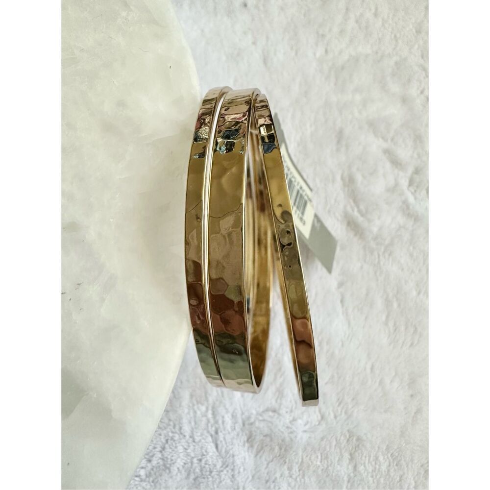Set of three gold hammered bangle bracelets ￼